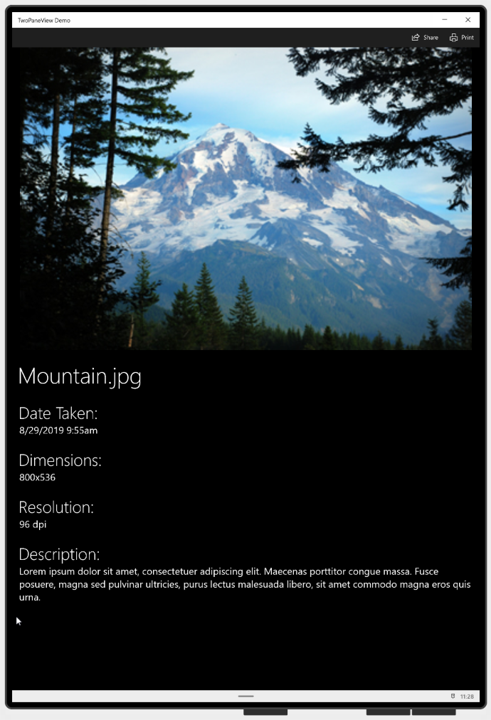 Two-pane view app in tall mode, with a photo of a mountain on the top and information about the photo on the bottom.